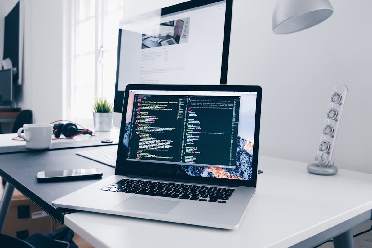Laptop and code in a web development workspace