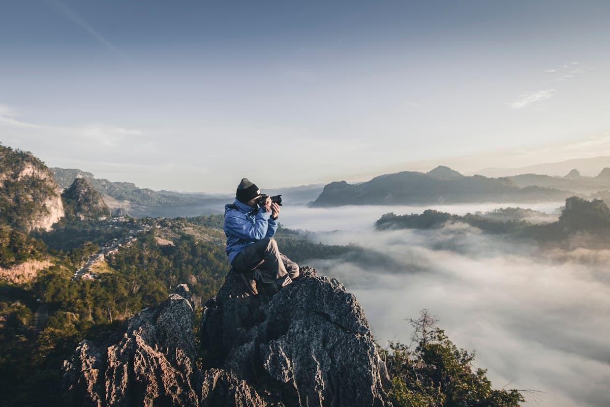Creator photographing a mountain landscape